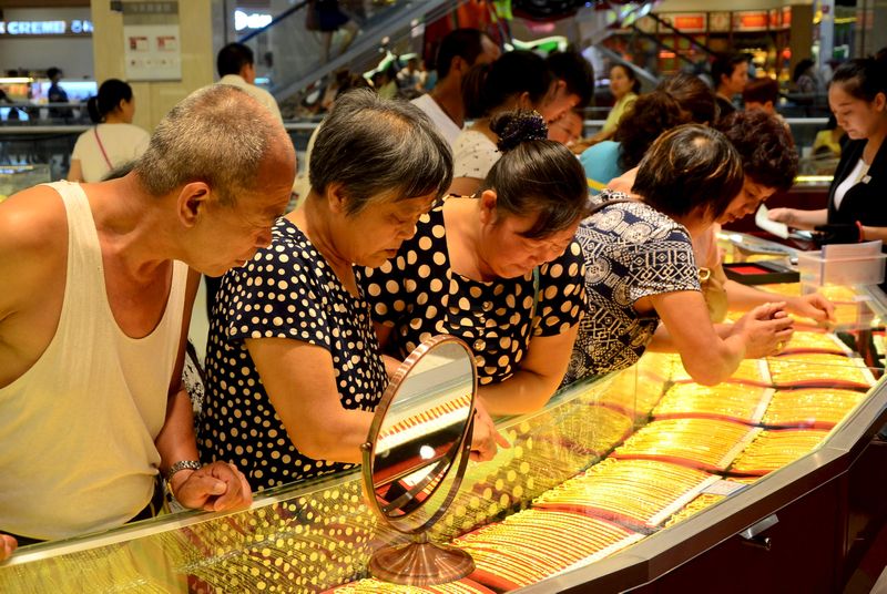 Customers look at gold necklaces at a jewelry store in Xuchang, Henan province, August 12, 2015. u00e2u20acu201d Reuters pic