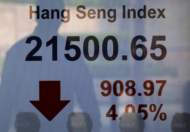 A passer-by is reflected on a panel displaying the Hang Seng Index, which drops more than four per cent, at the Hong Kong Stocks Exchange in Hong Kong, China August 24, 2015. u00e2u20acu201d Reuters pic