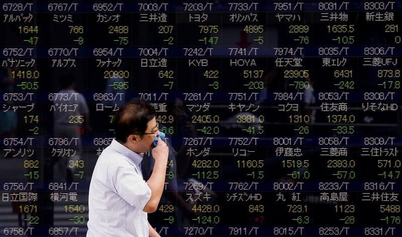 A man walks past a display showing stock prices in Tokyo August 12, 2015. Japan's Nikkei rose 0.6 per cent early August 17, 2015. u00e2u20acu201d Reuters pic