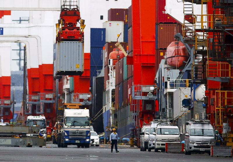 A crane lifts a cargo container onto a truck at a port in Tokyo July 23, 2015. Japan's exports have slowed in July compared to June. u00e2u20acu201d Reuters pic 