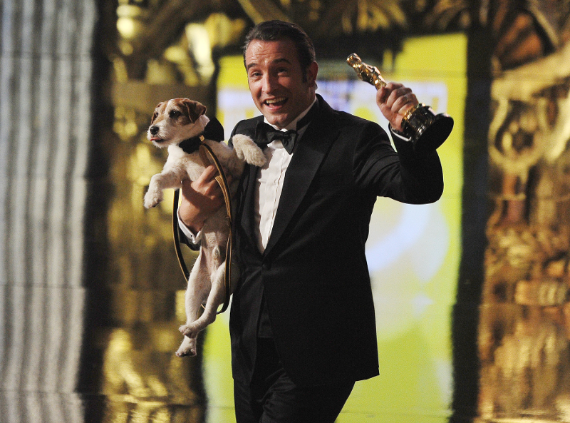 Best Actor winner Jean Dujardin walks off the stage with dog Uggie after 'The Artist' won Best Movie onstage at the 84th Annual Academy Awards on February 26, 2012 in Hollywood, California. u00e2u20acu201d AFP pic