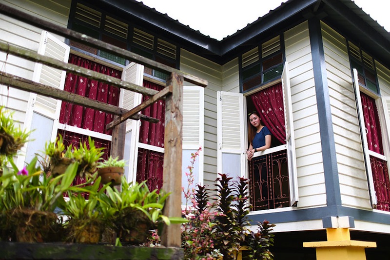 Tourist getting a taste of kampung lifestyle in a traditional Malay house at Kampung Lonek. 