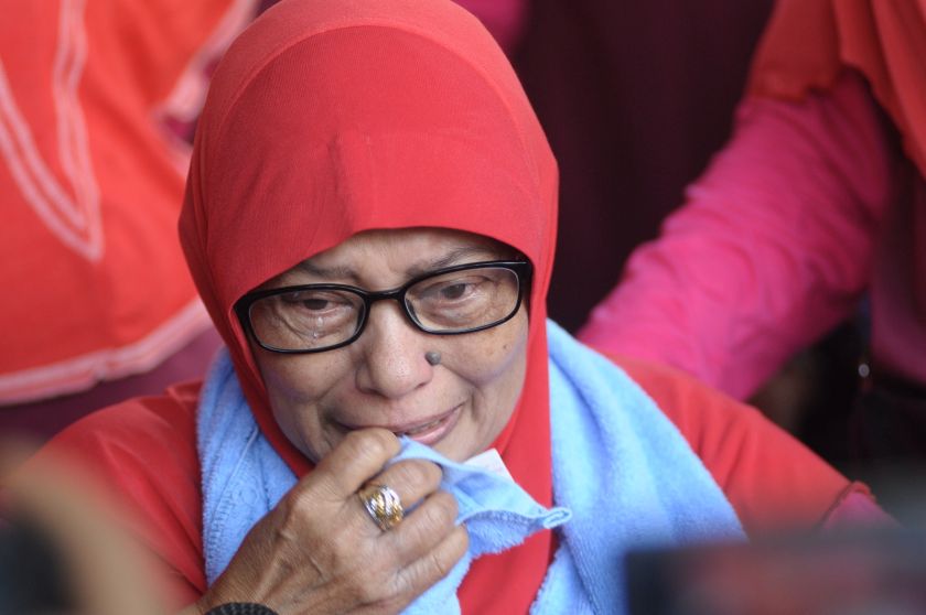 Kampung Mutiara resident Zamiyah Ismail, 61, wipes tears from her eyes as she worries about losing her home in the village. u00e2u20acu201d Picture by K.E.Ooi