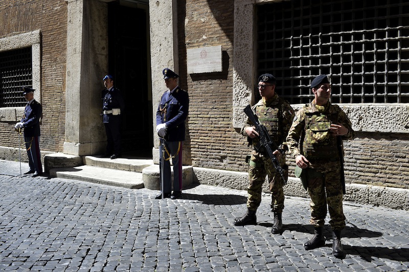 Policemen and soldiers stand guard outside the Italian national Anti-mafia services headquarters on May 7, 2015 in Rome. u00e2u20acu201d AFP pic