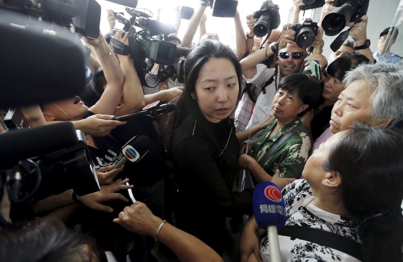 A Malaysia Airlines Beijing office staff member is surrounded as she invites relatives of passengers of Malaysian Airlines flight MH370 to the office in Beijing August 6, 2015. u00e2u20acu201d Reuters pic 