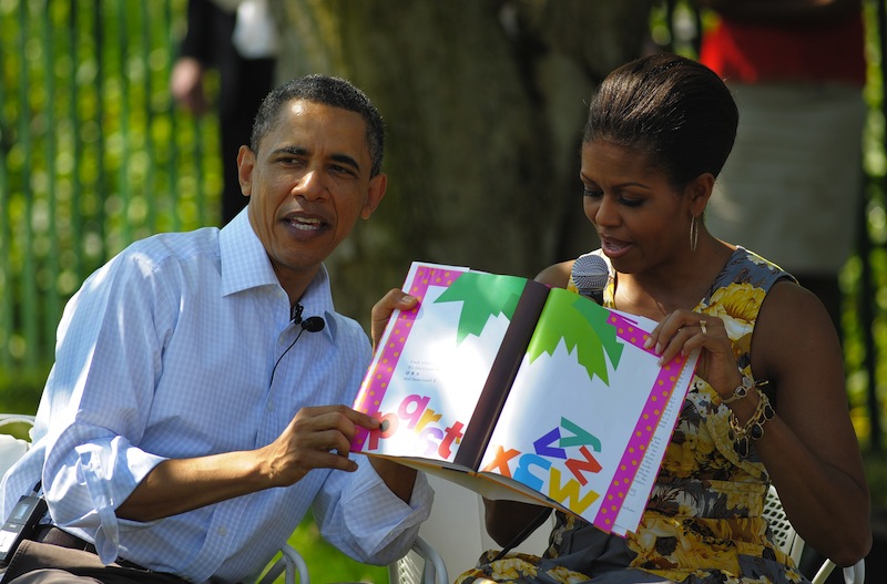 US President Barack Obama and First Lady Michelle Obama read a book to children during the annual Easter egg roll April 25, 2011 on the South Lawn of the White House in Washington, DC. u00e2u20acu201d AFP pic