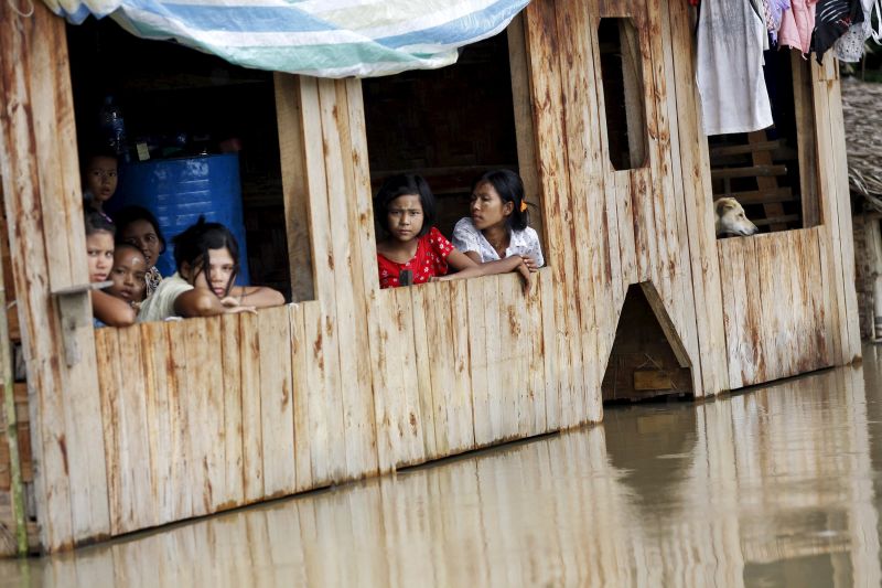 People sit at their home in a flooded village outside Zalun Township, Irrawaddy Delta, Myanmar. u00e2u20acu201d Reuters pic