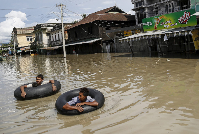 Men wade along a flooded street at Kalay township at Sagaing division, August 2, 2015. u00e2u20acu201d Reuters pic