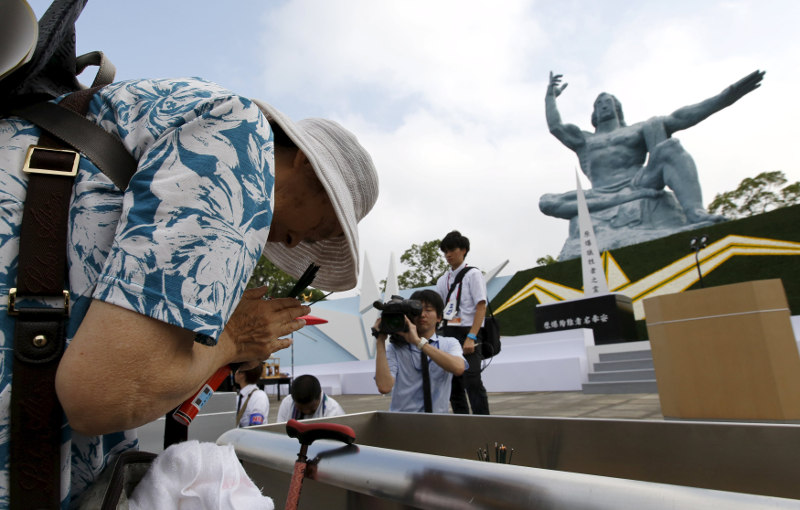 A woman prays for victims of the 1945 atomic bombing in front of the Peace Statue before a ceremony commemorating the 70th anniversary of the bombing, at Nagasakiu00e2u20acu2122s Peace Park in Nagasaki, Japan, August 9, 2015. u00e2u20acu201d Reuters pic