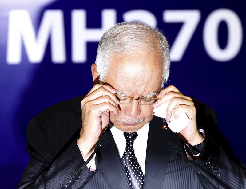 Malaysia's Prime Minister Najib Razak adjusts his glasses before confirming the debris found on Reunion Island is from missing Malaysia Airlines flight MH370 in Kuala Lumpur, Malaysia, August 6, 2015. u00e2u20acu201d Reuters pic