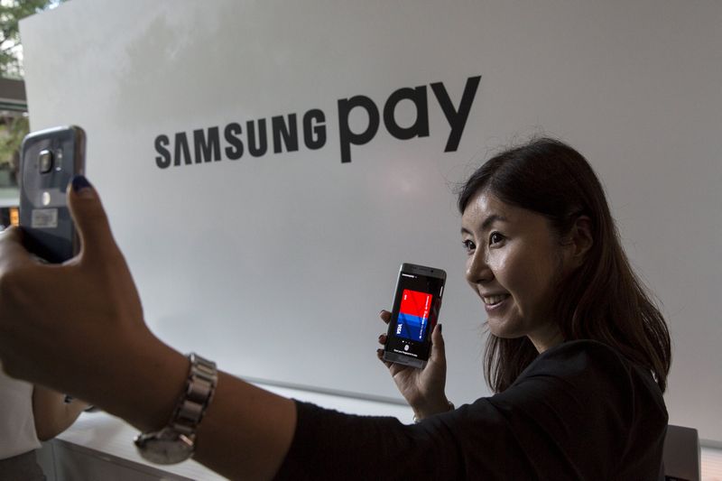 A woman takes a 'selfie' with a Samsung Galaxy S6 Edge+ near the Samsung Pay display at the Samsung Galaxy Unpacked 2015 event in New York August 13, 2015. u00e2u20acu201d Reuters pic 