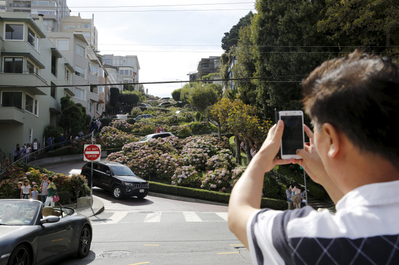A man snaps a photo of Lombard Street, a popular tourist spot also known as the 'world's crookedest street,' in San Francisco, California, August 26, 2015. u00e2u20acu201d Reuters pic