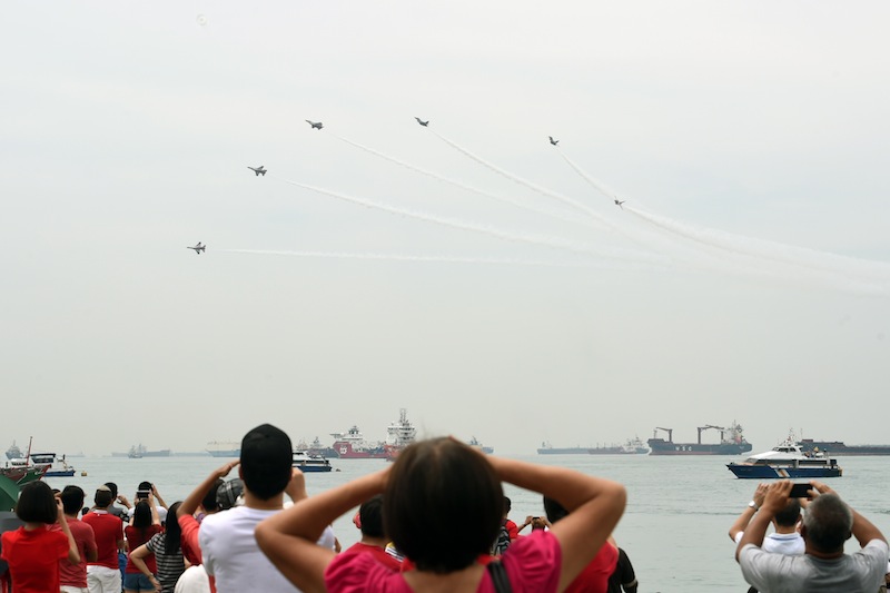F-16 fighter jets from the Republic of Singapore Air Force's aerobatics team, the Black Knights, perform an aerial display over Singapore on August 9, 2015. u00e2u20acu201d AFP pic