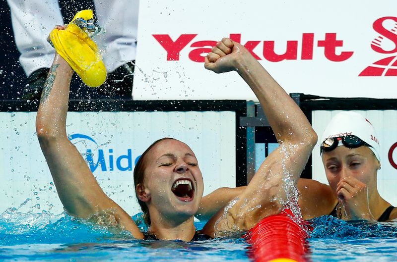 Sarah Sjostrom of Sweden celebrates after setting a women's 100m butterfly world record next to Katerine Savard (right) of Canada at the Aquatics World Championships in Kazan, Russia, August 2, 2015 u00e2u20acu201d Reuters pic