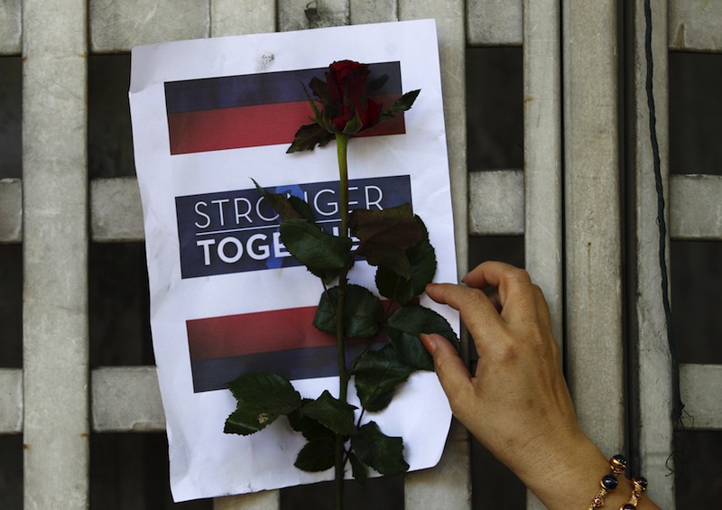 A woman leaves a rose for the victims at the site of a deadly blast in central Bangkok, Thailand, August 18, 2015.u00c2u00a0u00e2u20acu201d Reuters pic