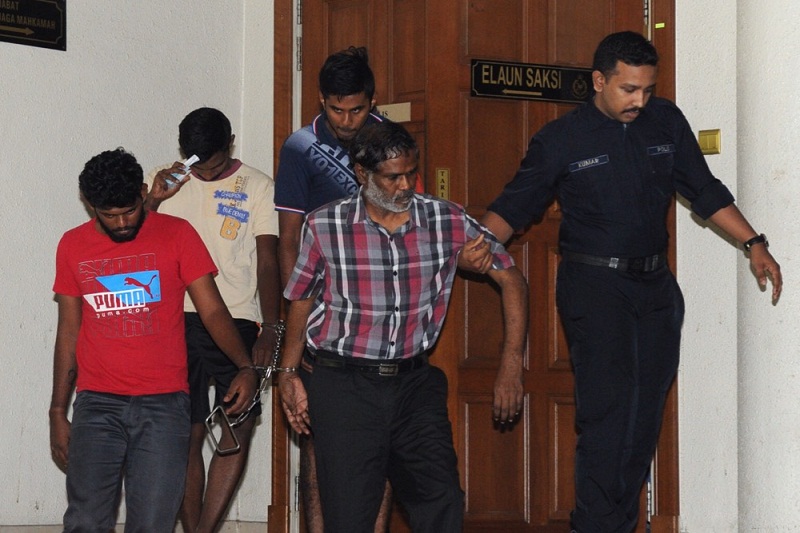 The men charged with murdering DPP Kevin Moraisu00e2u20acu2122 are led by policemen outside the Duta Court Complex in Kuala Lumpur, September 28, 2015. u00e2u20acu201d Picture by Choo Choy May