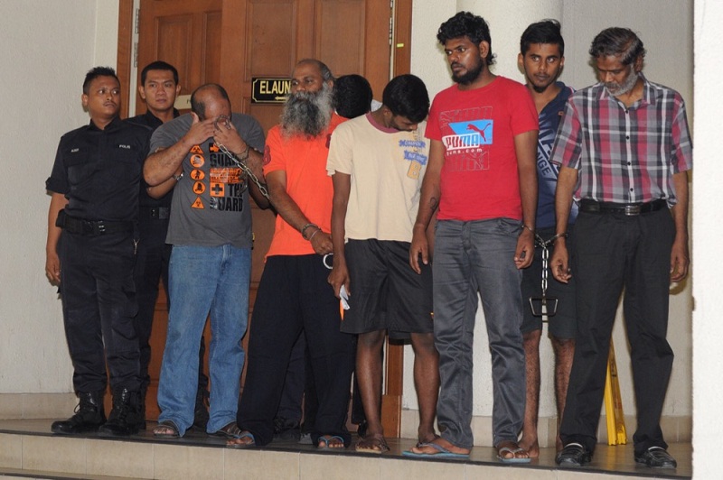 The men charged with murdering DPP Kevin Moraisu00e2u20acu2122 are led by policemen outside the Duta Court Complex in Kuala Lumpur, September 28, 2015. u00e2u20acu201d Picture by Choo Choy May