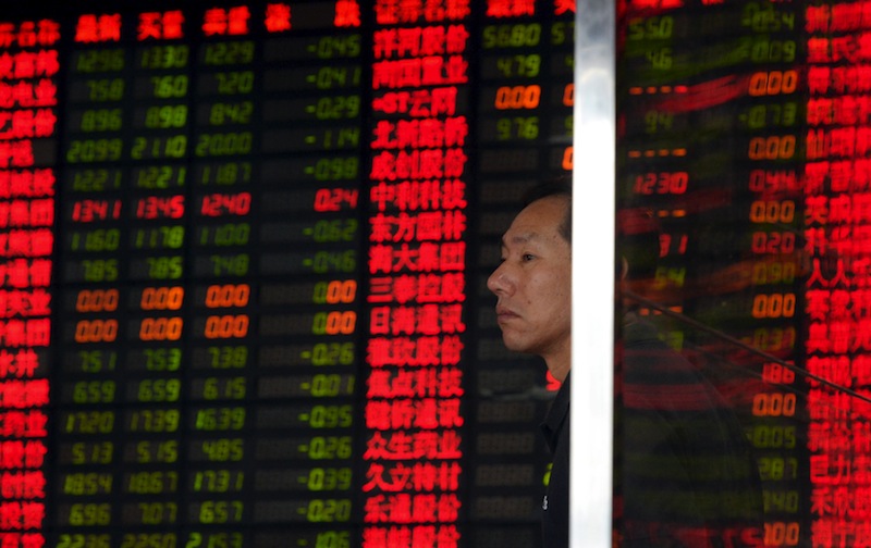 An investor stands in front of an electronic board showing stock information at a brokerage house in Shanghai, China, September 2, 2015. u00e2u20acu201d Reuters pic