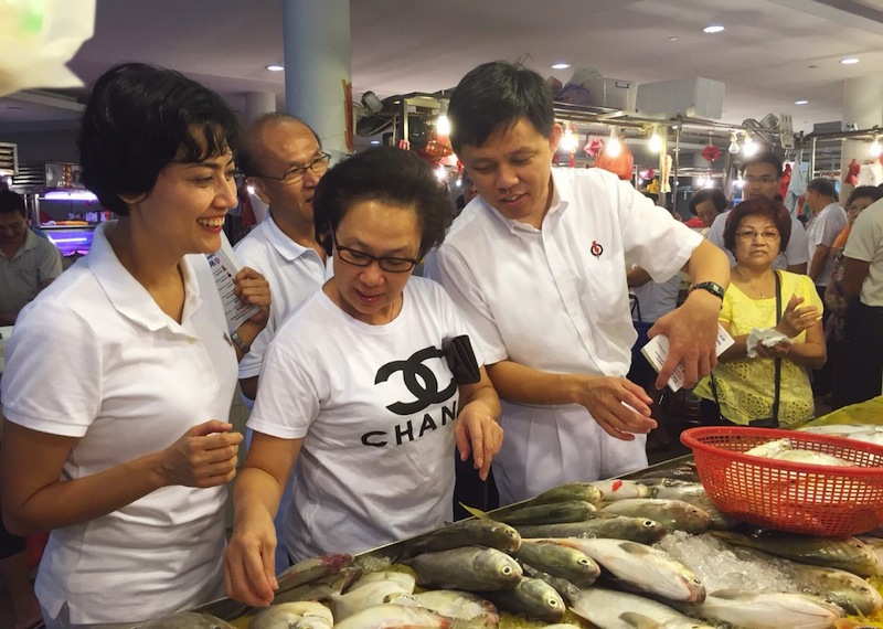 PAP candidates for Tanjong Pagar GRC Chan Chun Sing (fourth from left) and Joan Pereira (left) during a walkabout at Tiong Bahru market yesterday. u00e2u20acu201d TODAY pic