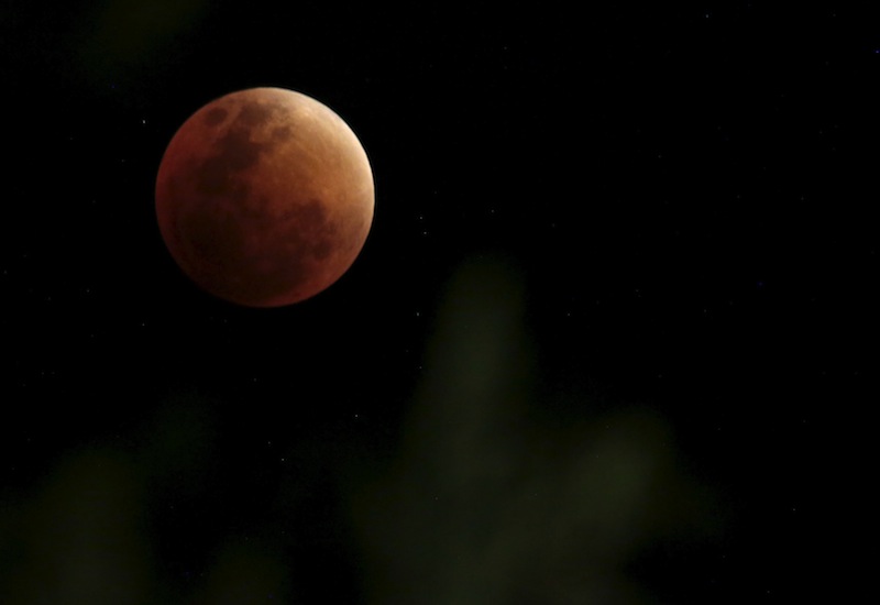 The Moon, appearing in a dim red colour, is covered by the Earth's shadow during a total lunar eclipse ove La Paz, September 27, 2015.u00c2u00a0u00e2u20acu201d Reuters pic