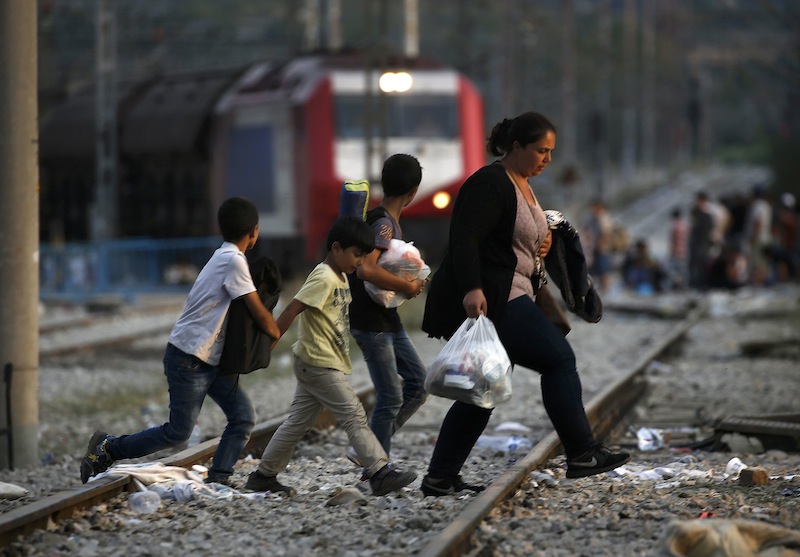 A Syrian refugee family walks across rail tracks near Greece's border with Macedonia, outside the village of Idomeni, September 7, 2015.u00c2u00a0u00c2u00a0u00e2u20acu201d Reuters pic