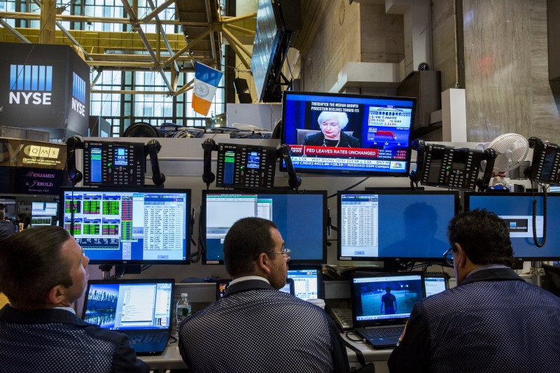 Traders work underneath a television screen showing Federal Reserve Chair Janet Yellen announcing that the Federal Reserve will leave interest rates unchanged on the floor of the New York Stock Exchange in New York September 17, 2015. u00e2u20acu201d Reuters pic