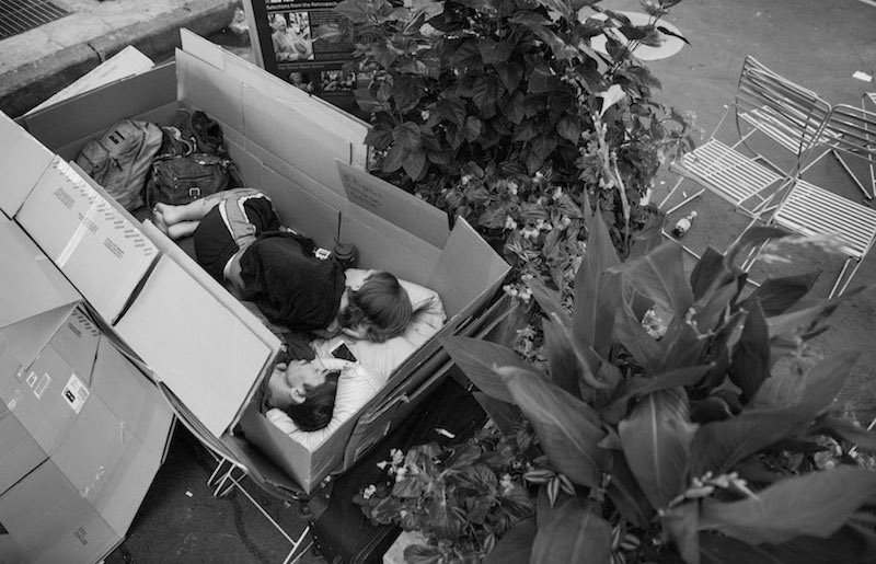 CJ and Tiffany Dillinger, homeless since their house in Old Bridge, New Jersey, was foreclosed on a year ago, sit in a box on Broadway in New York, September 3, 2015. — Picture by Joshua Bright/The New York Times
