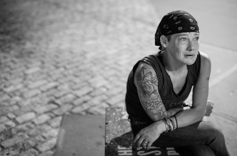 Heather Pittenger, who has been homeless since 1999 and avoids shelters, calling them ‘unsafe,’ reacts as she tells her story of hardship outside Heritage Field in New York, September 2, 2015. — Picture by Joshua Bright/The New York Times