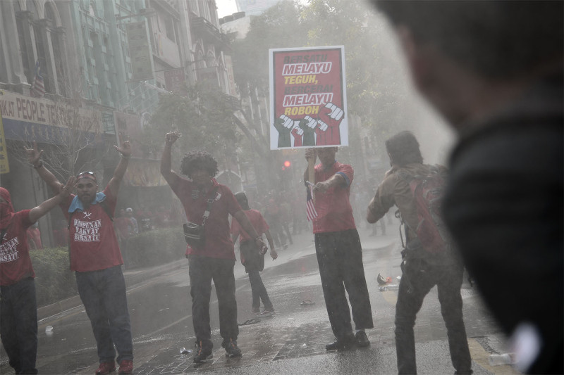Riot police fire water cannons at the Himpunan Rakyat Bersatu protesters near Petaling Street, September 16, 2015. u00e2u20acu201d Picture by Yusof Mat Isa