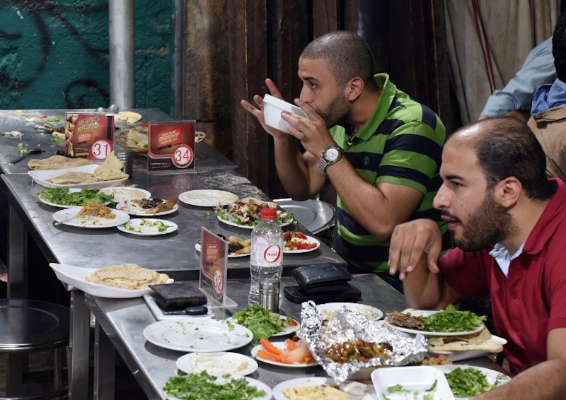 Egyptians eat at the Kaber Subhi restaurant in Cairo’s northern suburb of Shubra, on September 1, 2015. . — AFP pic