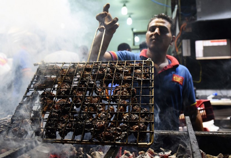 An Egyptian cook prepares meat at the Kaber Subhi restaurant in Cairo’s northern suburb of Shubra, on September 1, 2015. . — AFP pic