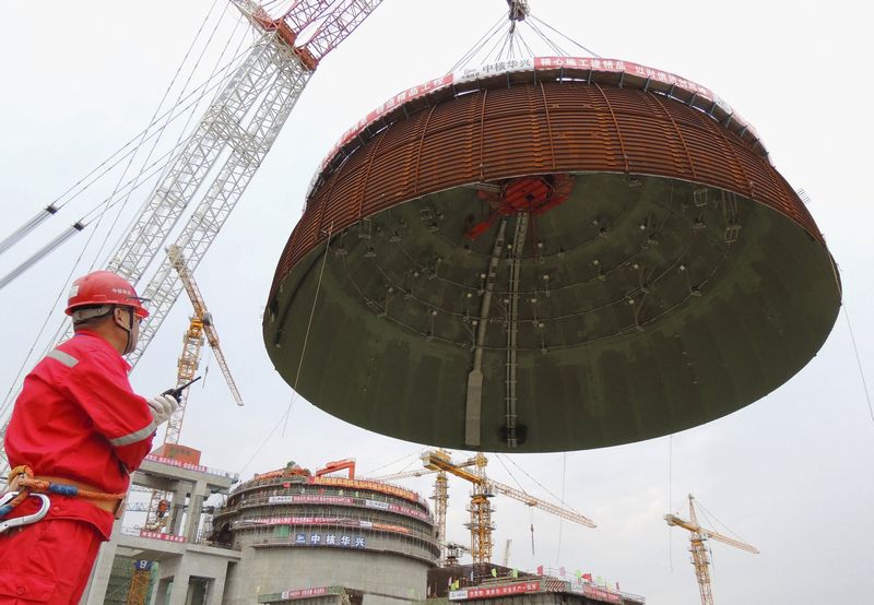 A worker looks on as the dome roof of a generator unit is lifted to be installed at Tianwan Nuclear Power Plant in Lianyungang, China, September 26, 2015. u00e2u20acu201d Reuters pic