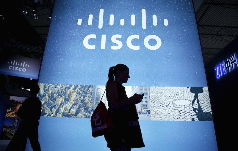 A visitor walks past a Cisco advertising panel at the Mobile World Congress in Barcelona in this February 27, 2014 file photo. u00e2u20acu201d Reuters pic