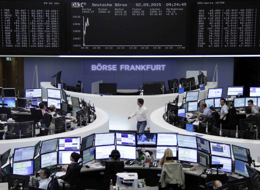 Traders are pictured at their desks in front of the DAX board at the Frankfurt stock exchange September 2, 2015. u00e2u20acu201d Reuters pic