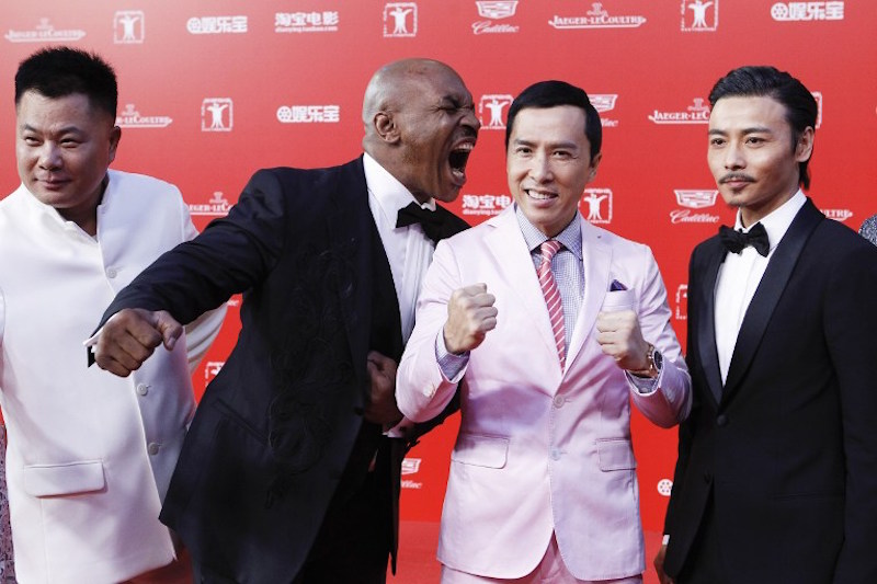 Retired professional boxer Mike Tyson jokes around with Donnie Yen as they arrive for the opening ceremony of Shanghai International Film Festival in Shanghai June 13, 2015. u00e2u20acu201d AFP pic