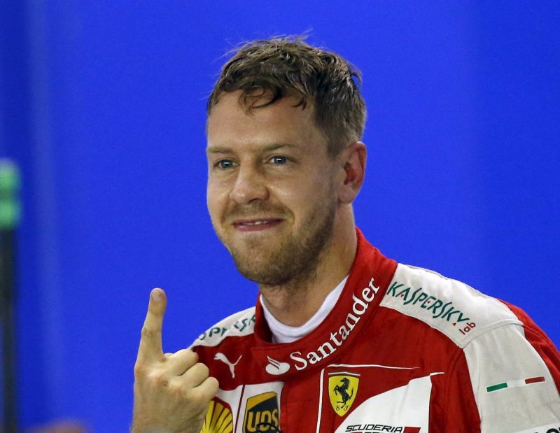 Ferrari Formula One driver Sebastian Vettel of Germany, after qualifying for pole at the Singapore F1 Grand Prix at the Marina Bay street circuit September 19, 2015. REUTERS/Olivia Harris
