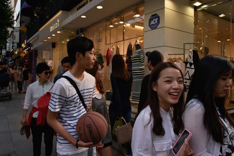 In a photo taken on August 29, 2015 shoppers walk in the upmarket Garuso-gil area of Gangnam, in Seoul. — AFP pic
