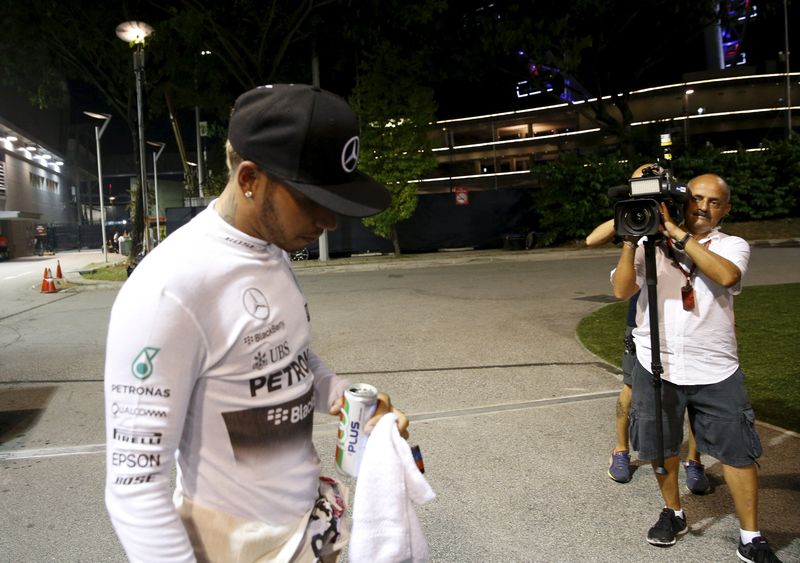 Mercedes Formula One driver Lewis Hamilton of Britain walks from his team's garage after retiring from the Singapore F1 Grand Prix at the Marina Bay street circuit September 20, 2015. u00e2u20acu201d Reuters pic
