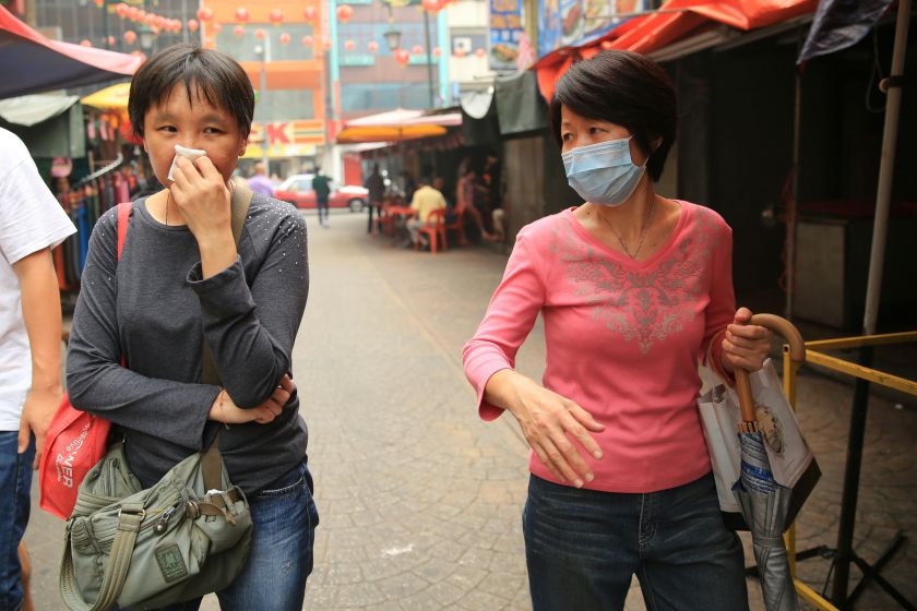 Shoppers are seen covering their noses and wearing masks as they shop in Petaling Street, Kuala Lumpur, September 26, 2015. u00e2u20acu201d Picture by Saw Siow Feng