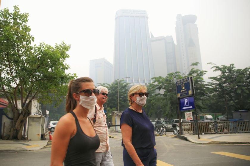 Tourists wear masks on Petaling Street, Kuala Lumpur, September 26, 2015. u00e2u20acu201d Picture by Saw Siow Feng