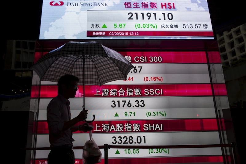 A man walks past a panel displaying figures of China stock indexes and Hang Seng Index at the financial Central district in Hong Kong, China September 2, 2015.u00c2u00a0u00e2u20acu201d Reuters pic