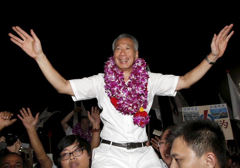 Singapore's Prime Minister  Lee Hsien Loong celebrates with supporters after the general election results at a stadium in Singapore September 12, 2015. u00e2u20acu201d Reuters pic