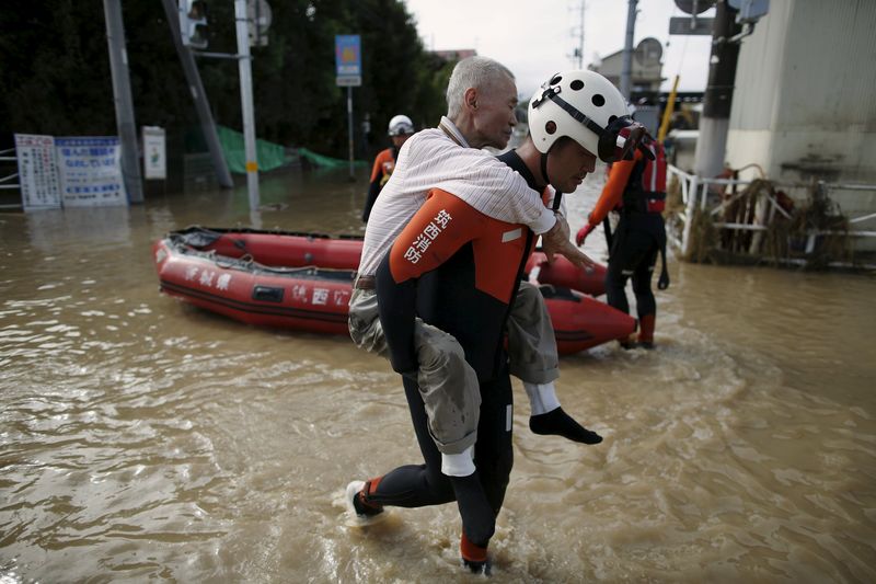 An elderly man is rescued by a firefighter at a residential area flooded by the Kinugawa river, caused by typhoon Etau in Joso, Japan, September 11, 2015. u00e2u20acu201d Reuters pic 