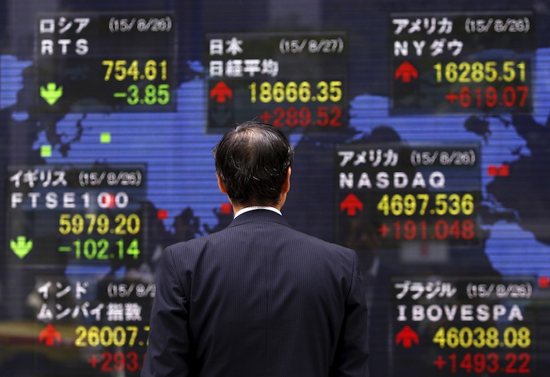 A pedestrian looks at an electronic board showing the stock market indices of various countries outside a brokerage in Tokyo, Japan, August 27, 2015.u00c2u00a0u00e2u20acu201d Reuters pic