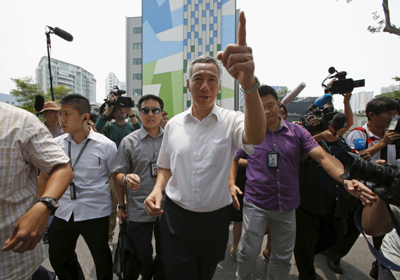 Singaporeu00e2u20acu2122s Prime Minister and Secretary-General of the Peopleu00e2u20acu2122s Action Party Lee Hsien Loong gestures as he leaves after casting his vote at a polling centre in Singapore September 11, 2015. u00e2u20acu201d Reuters pic