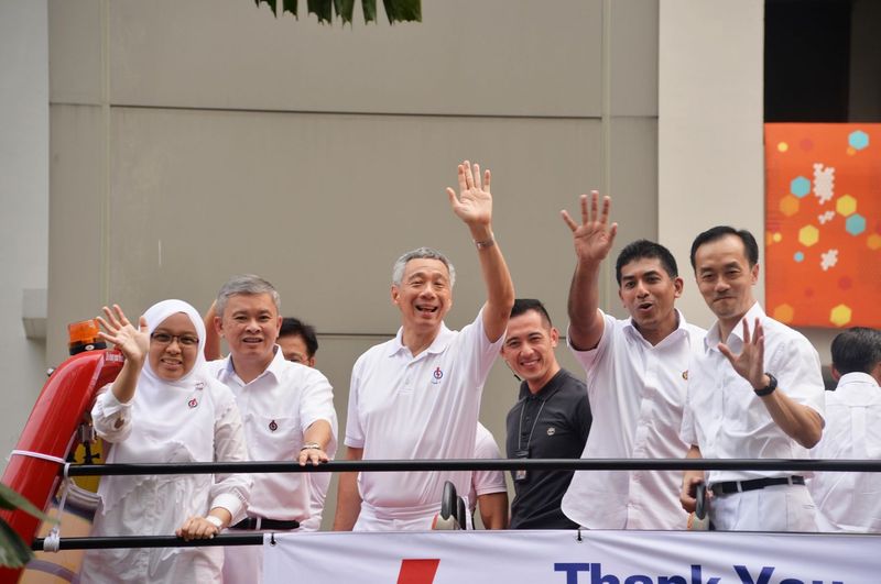 Singapore Prime Minister Lee Hsien Loong (centre) and his team for Ang Mo Kio GRC on a victory parade on a bus, September 12, 2015. u00e2u20acu201d TODAY pic