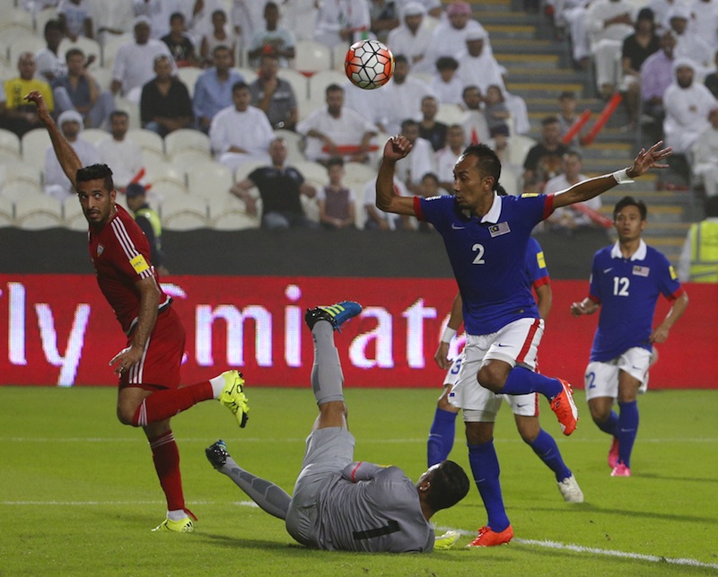 UAE's Ali Ahmed Mabkhout (left) fights for the ball with Malaysia's Mohd Afif Amiruddin (centre) and Muhammad Zamir during their AFC qualifying football match for the 2018 FIFA World Cup at the Mohammed Bin Zayed Stadium in Abu Dhabi on September 3, 2015.
