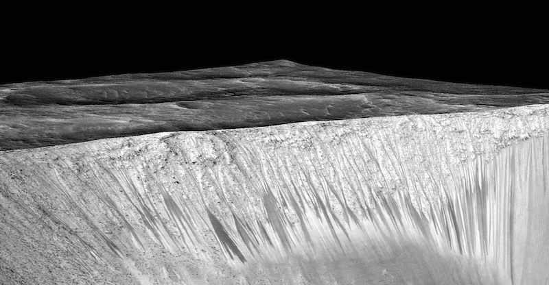 Dark narrow streaks called recurring slope lineae emanating out of the walls of Garni crater on Mars are seen in an image produced by NASA, Jet Propulsion Laboratory (JPL) and the University of Arizona. — Reuters pic