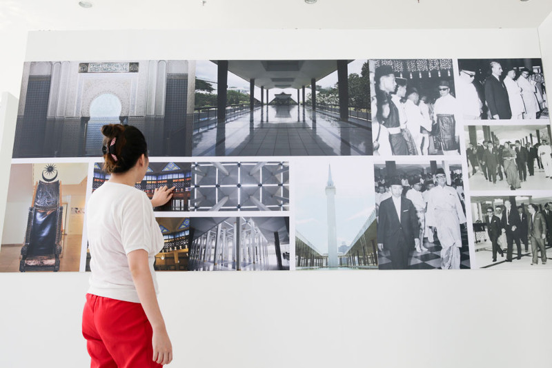 A visitor looks at photographs of Masjid Negara's past at the 50 Years National Mosque Exhibition.