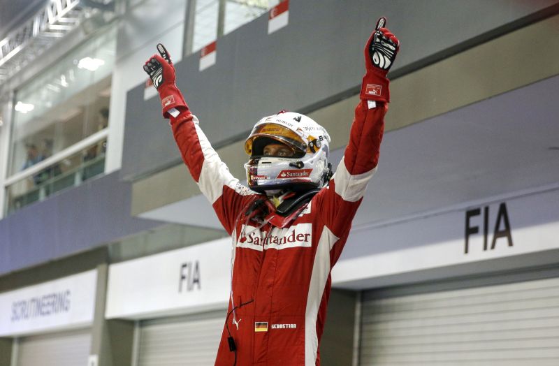 Ferrari Formula One driver Sebastian Vettel of Germany rejoices winning the Singapore F1 Grand Prix at the Marina Bay street circuit September 20, 2015. REUTERS/Edgar Su